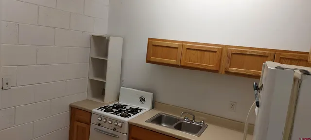 a kitchen with stainless steel appliances a refrigerator and a stove top oven