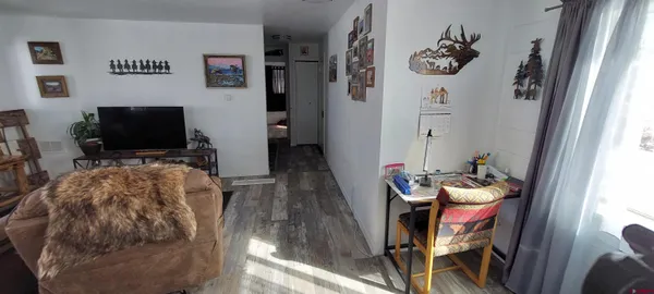 a living room with furniture and flat screen tv