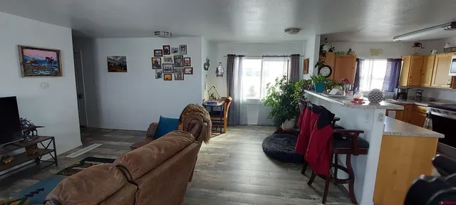 a living room with furniture gym equipment and a flat screen tv