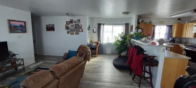 a living room with furniture gym equipment and a flat screen tv