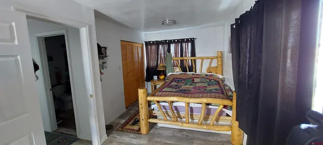 a bed room with a bed and a window