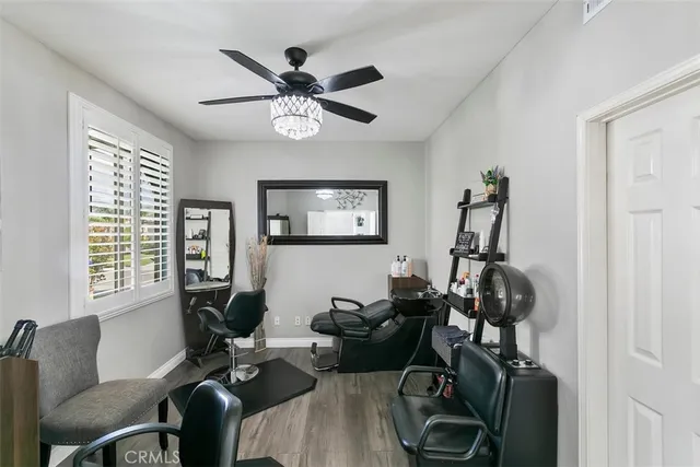 a view of a livingroom with furniture and a gym cycle