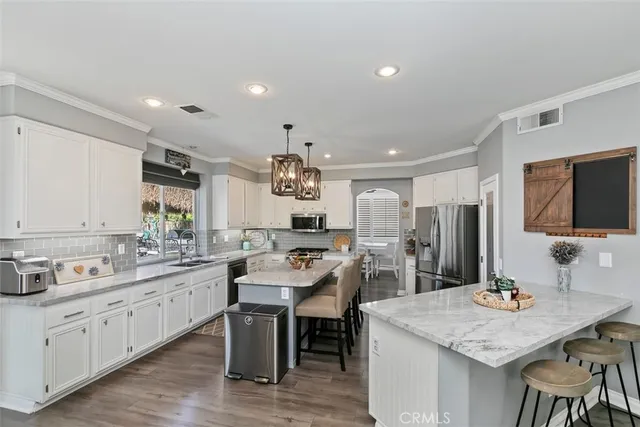 a kitchen with counter space cabinets appliances and a center island