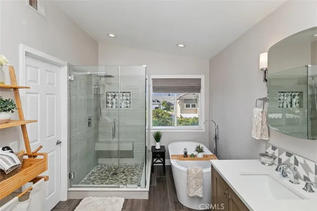 a bathroom with a sink a toilet a shower and a mirror