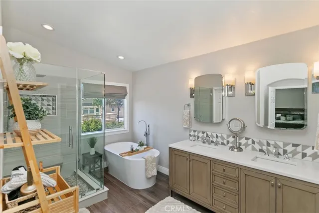 a bathroom with a granite countertop sink mirror and bathtub