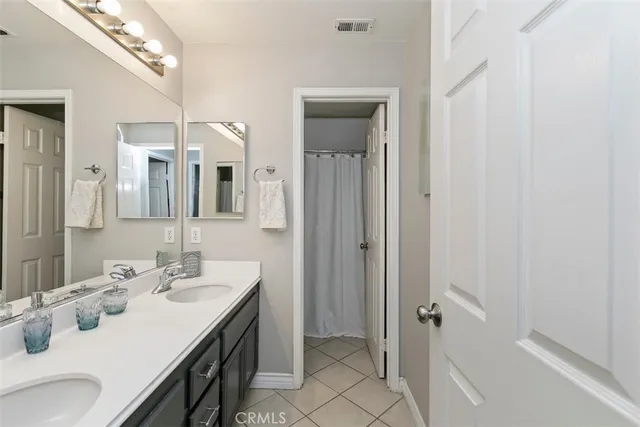 a bathroom with a sink vanity and a mirror