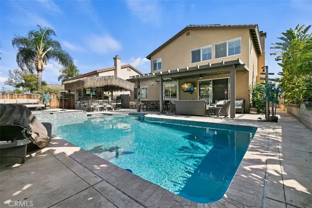 a swimming pool with outdoor seating and yard