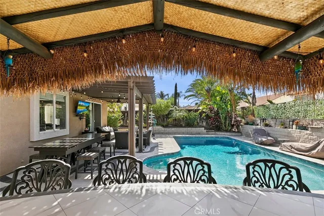 a couple of table and chairs under an umbrella