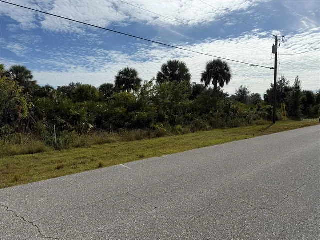 a view of a field of grass and trees