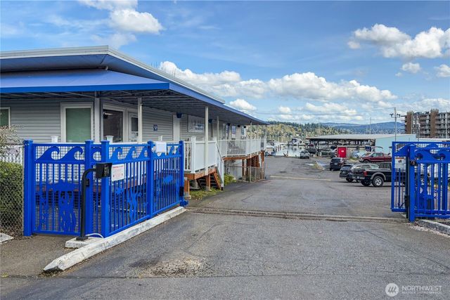 a view of swimming pool with outdoor seating and house in the background