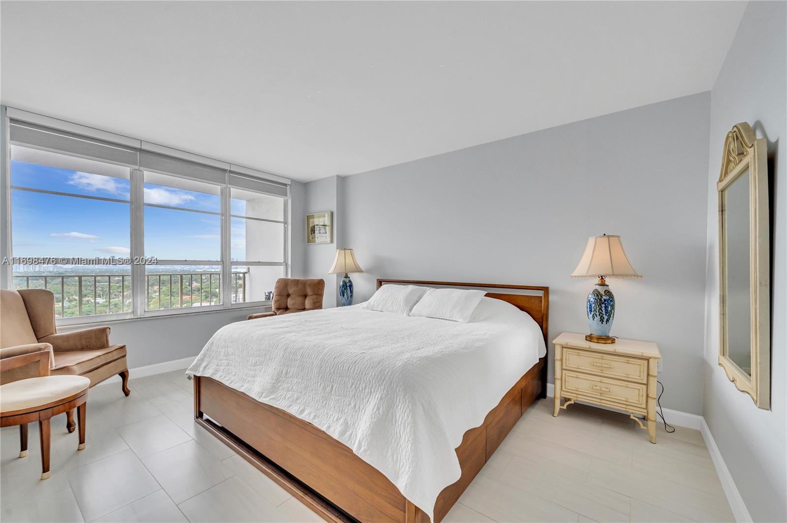4101 Pine Tree Drive, Unit 1702 Miami Beach, FL 33140 - Photo 16 of 51 a spacious bedroom with a bed and a large window