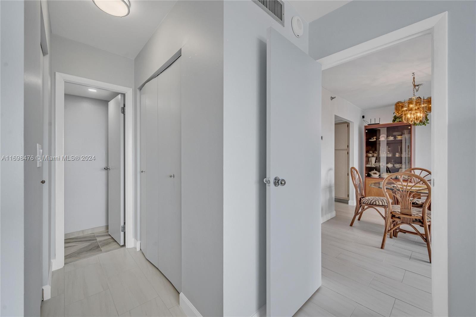4101 Pine Tree Drive, Unit 1702 Miami Beach, FL 33140 - Photo 20 of 51 a view of dining room with furniture and chandelier