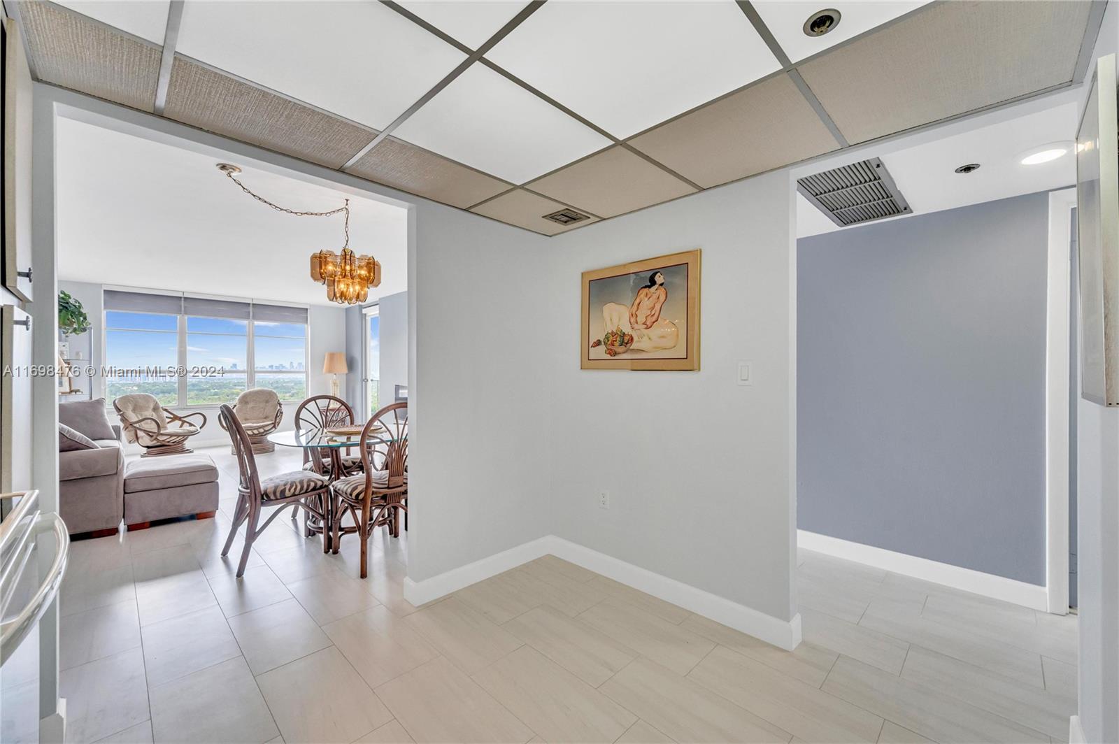 4101 Pine Tree Drive, Unit 1702 Miami Beach, FL 33140 - Photo 23 of 51 a dinning room with furniture and a table