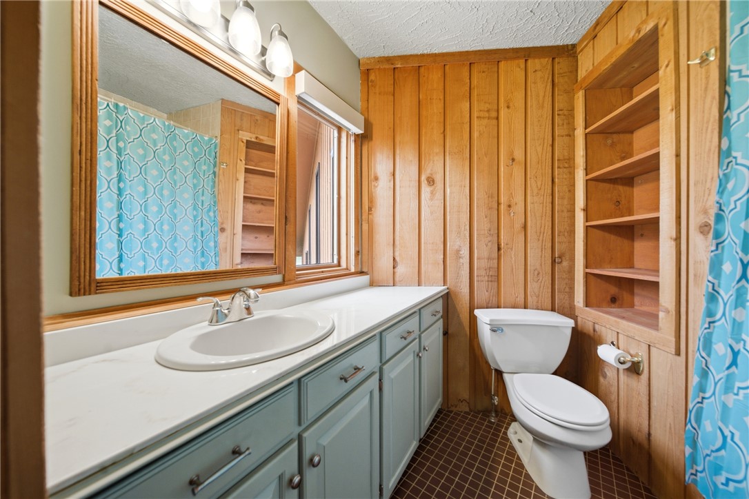 1531 Highway 252 Laurens, SC 29360 - Photo 13 of 40 This cozy bathroom features natural wood paneling and a practical vanity with ample storage.