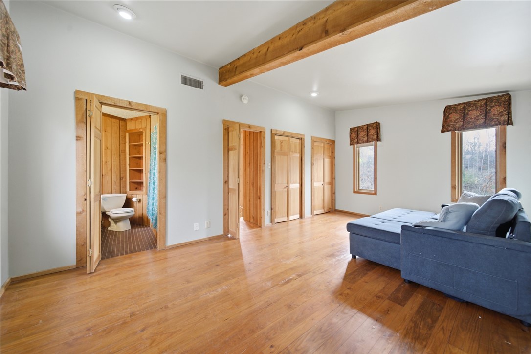 1531 Highway 252 Laurens, SC 29360 - Photo 14 of 40 This bright space features polished wood floors and exposed ceiling beams, creating a warm, inviting atmosphere.