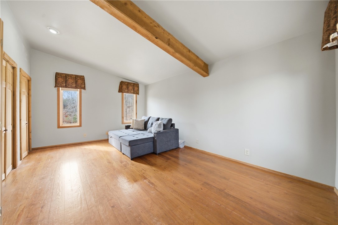 1531 Highway 252 Laurens, SC 29360 - Photo 15 of 40 This airy room features rich hardwood flooring and a vaulted ceiling with exposed wooden beams.