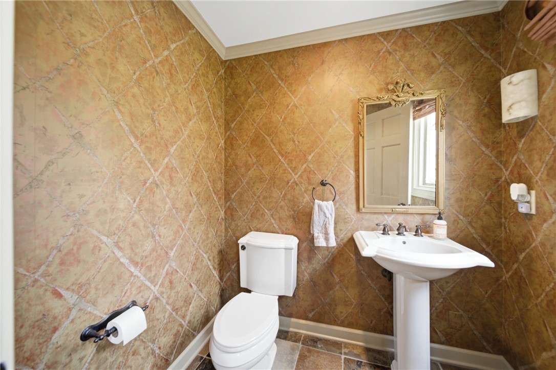 1531 Highway 252 Laurens, SC 29360 - Photo 20 of 40 This powder room features an elegant pedestal sink and intricate patterned walls.