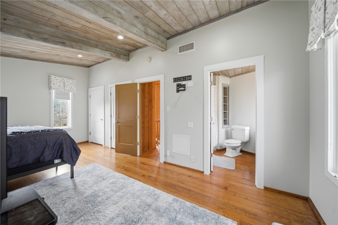 1531 Highway 252 Laurens, SC 29360 - Photo 23 of 40 This spacious bedroom features a wood plank ceiling and rich hardwood floors.