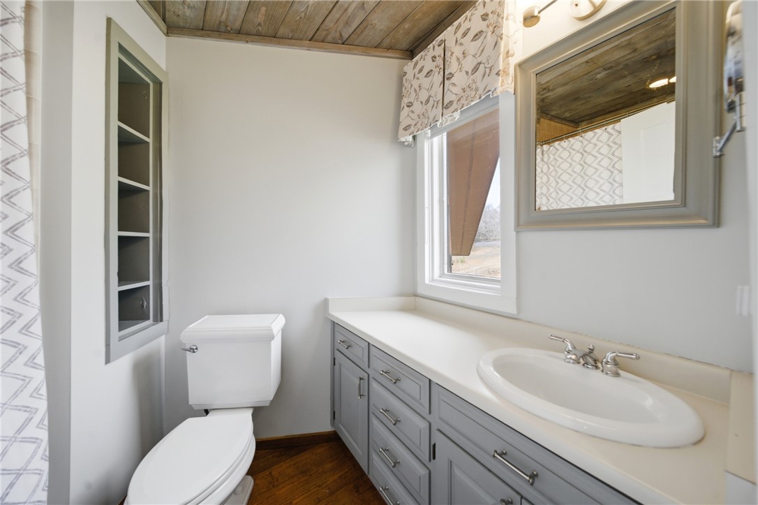 1531 Highway 252 Laurens, SC 29360 - Photo 25 of 40 This bathroom features a sleek vanity, convenient toilet, and a charming window for natural light.