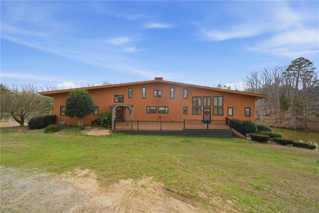 1531 Highway 252 Laurens, SC 29360 - Photo 30 of 40 This modern lakefront residence features a spacious deck and large windows, perfect for serene living.