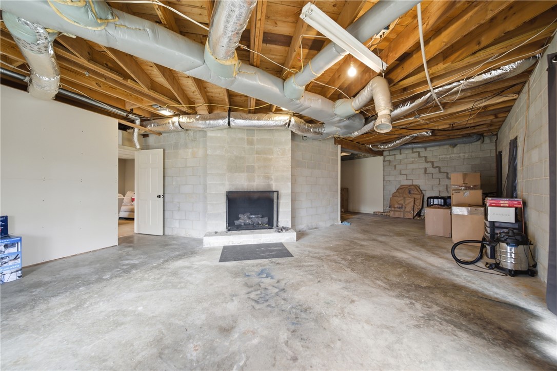 1531 Highway 252 Laurens, SC 29360 - Photo 39 of 40 This expansive basement offers an ideal canvas for future customization, featuring a sturdy fireplace.
