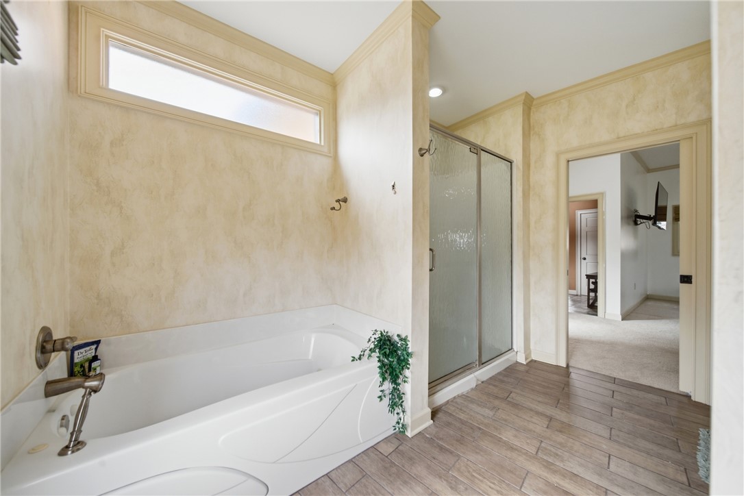 1531 Highway 252 Laurens, SC 29360 - Photo 5 of 40 This serene bathroom offers a spacious soaking tub and a sleek glass-enclosed shower.