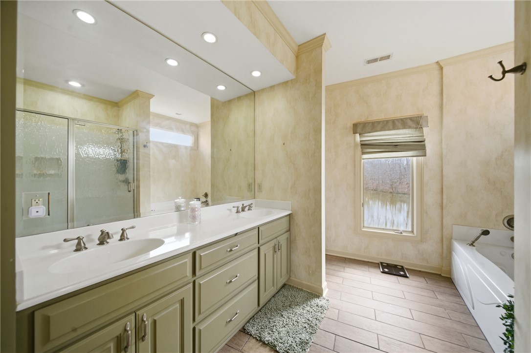 1531 Highway 252 Laurens, SC 29360 - Photo 6 of 40 This spacious bathroom offers dual sinks, a shower, a large soaking tub, and a scenic window view.