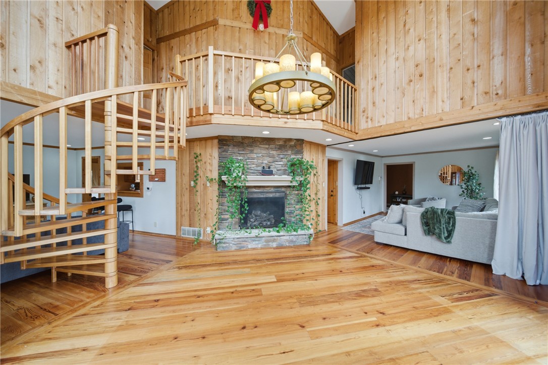 1531 Highway 252 Laurens, SC 29360 - Photo 10 of 40 This inviting interior features a grand spiral staircase and a cozy fireplace, perfect for gatherings.