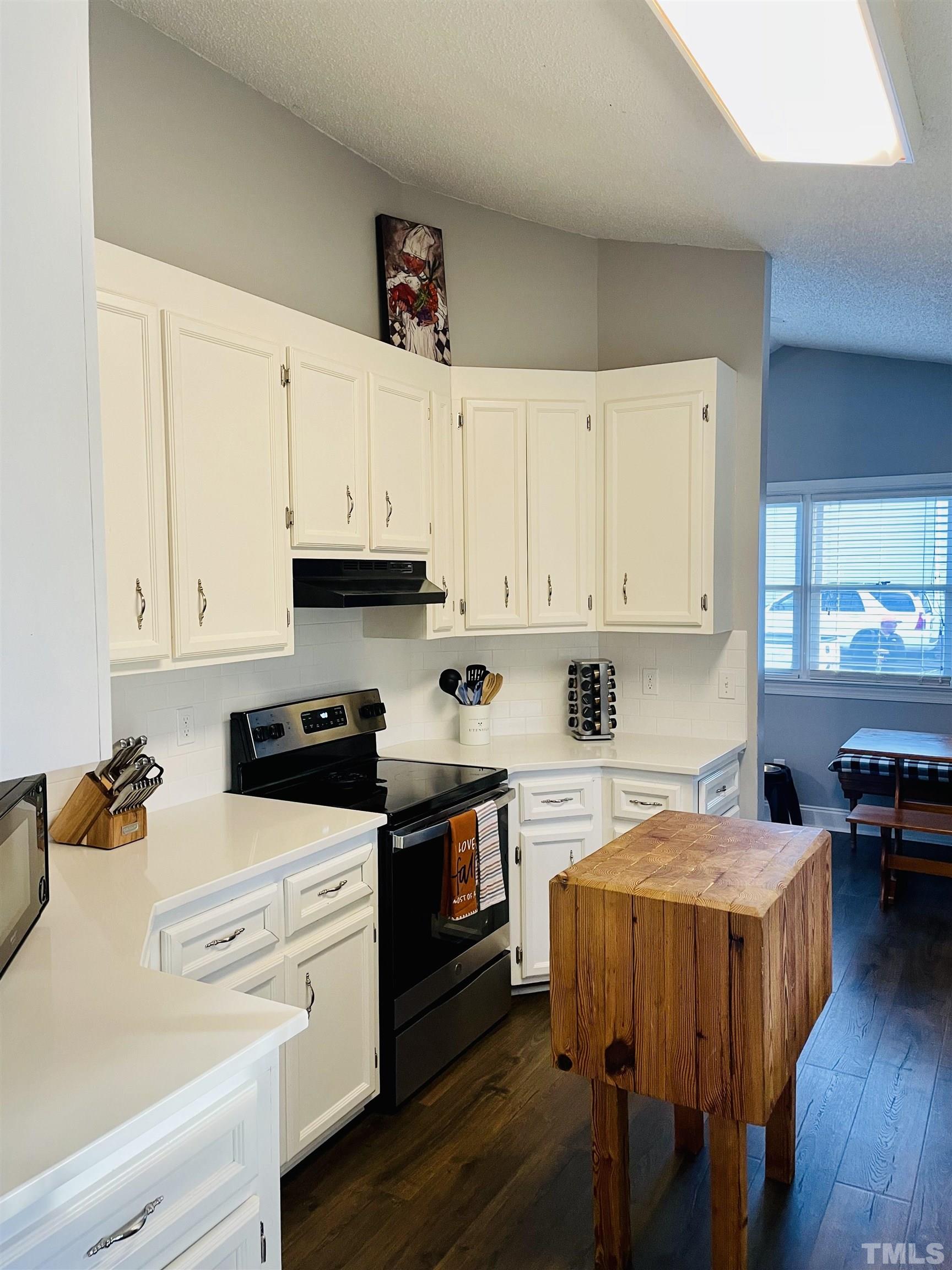 6908 Kiger Road Rougemont, NC 27572 - Photo 2 of 30 a kitchen with stainless steel appliances granite countertop a white cabinets and wooden floor
