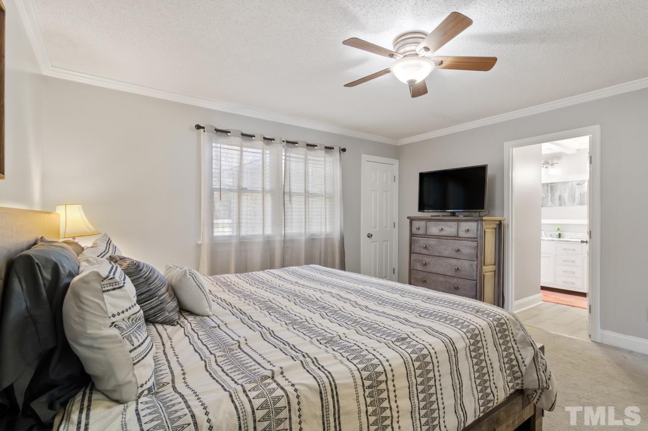 6908 Kiger Road Rougemont, NC 27572 - Photo 21 of 30 a bedroom with a bed and a tv