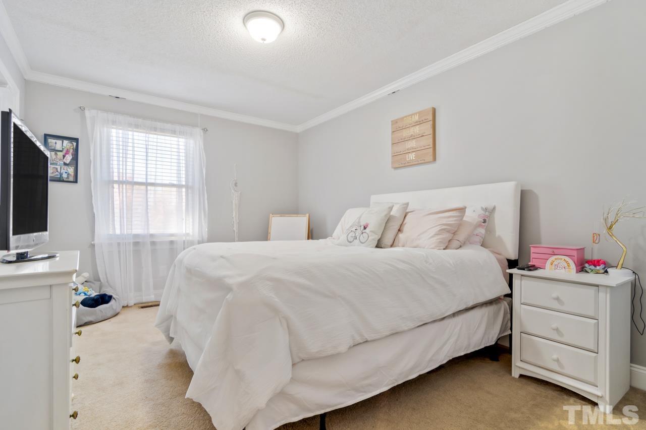 6908 Kiger Road Rougemont, NC 27572 - Photo 24 of 30 a bedroom with a bed and a flat screen tv