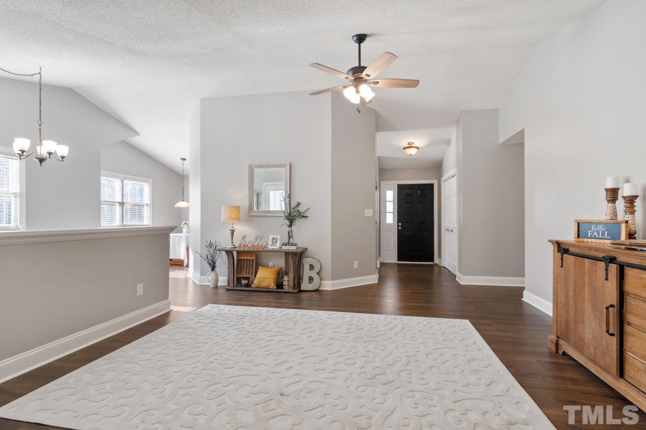 6908 Kiger Road Rougemont, NC 27572 - Photo 8 of 30 a living room with furniture and a chandelier