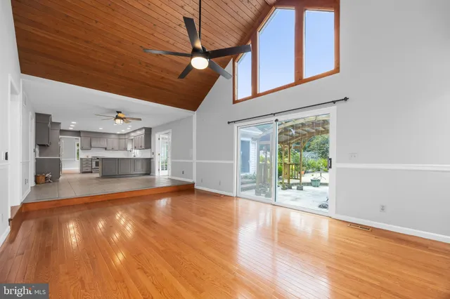 a bathroom with a toilet sink vanity and mirror