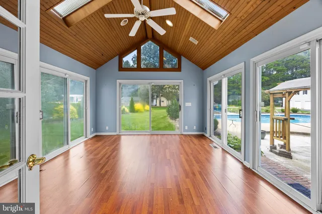 a view of a room with wooden floor and white walls