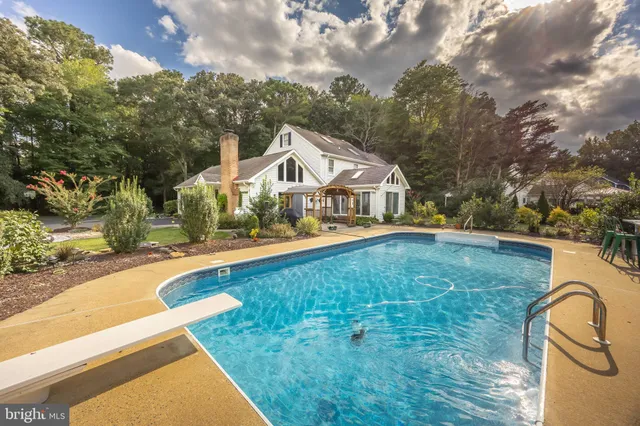 a kitchen with white cabinets and refrigerator