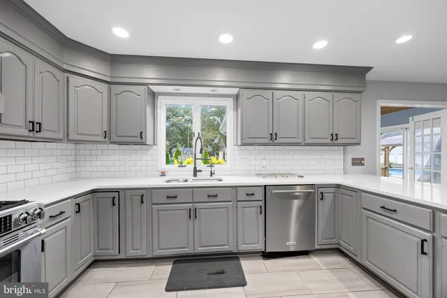 a view of a livingroom with wooden floor and a ceiling fan