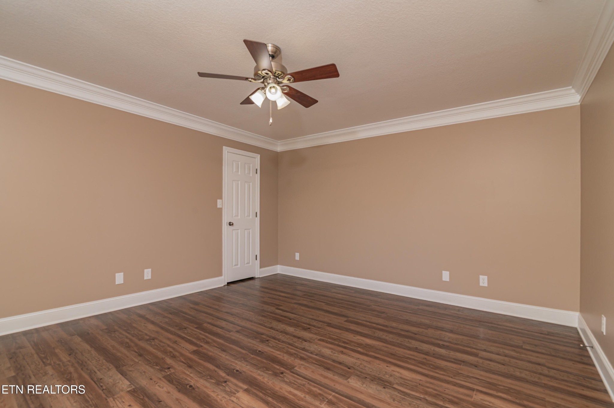 8007 Tazewell Pike Corryton, TN 37721 - Photo 12 of 43 a view of an empty room with wooden floor and a ceiling fan