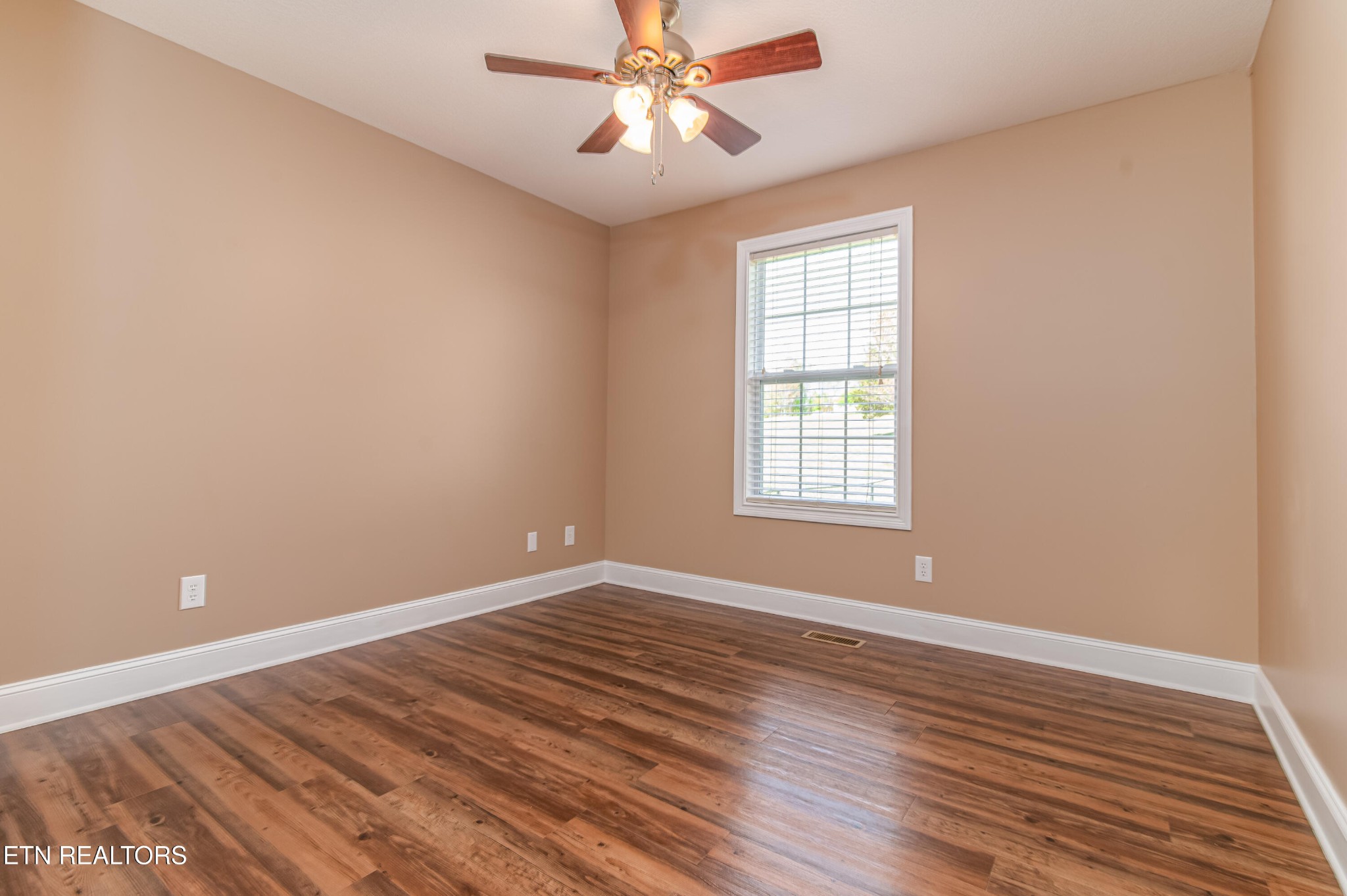 8007 Tazewell Pike Corryton, TN 37721 - Photo 18 of 43 wooden floor in an empty room with a window