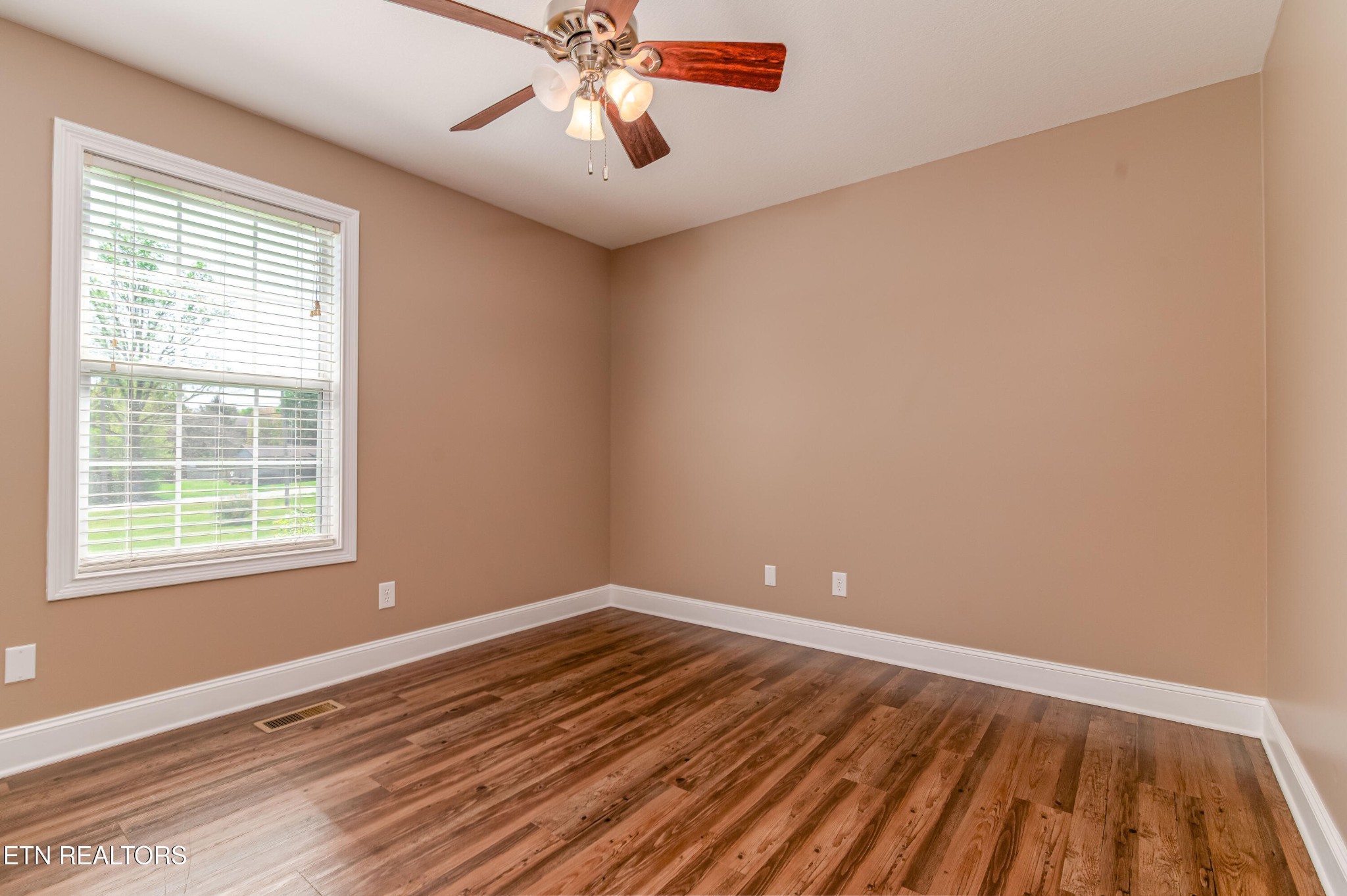 8007 Tazewell Pike Corryton, TN 37721 - Photo 20 of 43 wooden floor in an empty room with a window