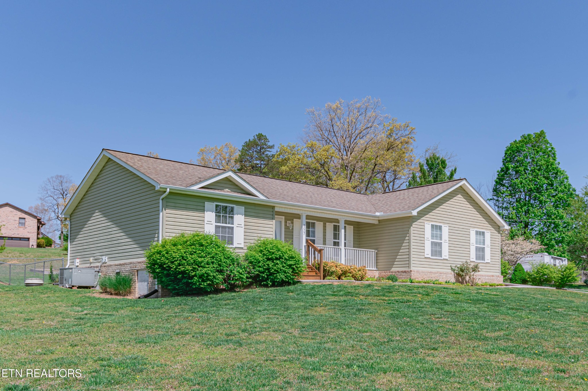 8007 Tazewell Pike Corryton, TN 37721 - Photo 2 of 43 a front view of a house with a garden