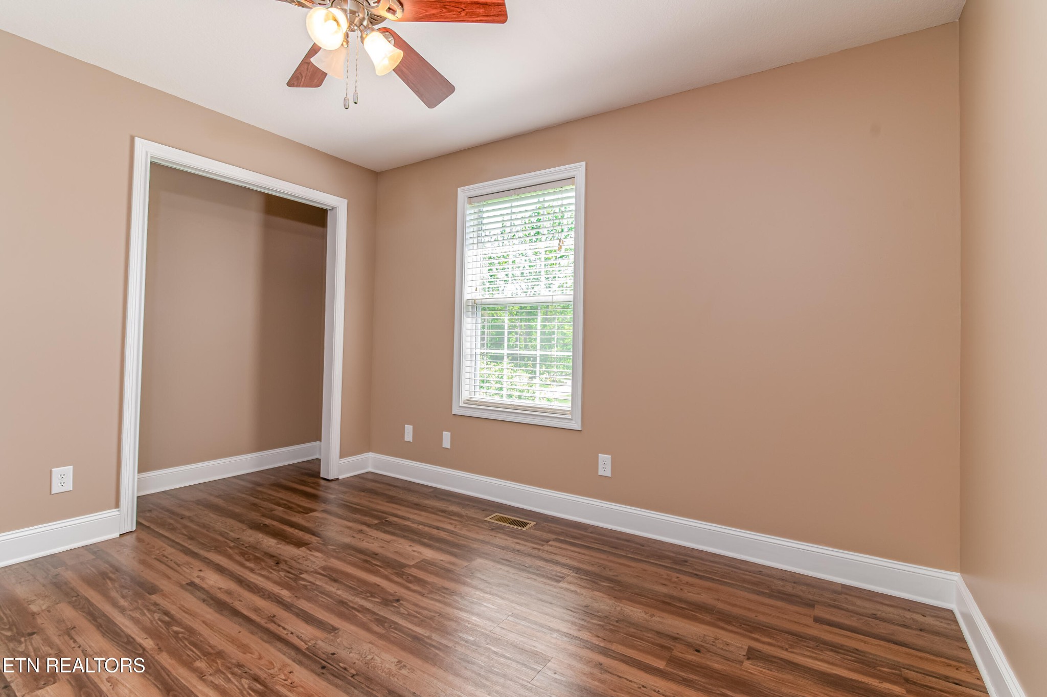 8007 Tazewell Pike Corryton, TN 37721 - Photo 21 of 43 a view of an empty room with wooden floor and a window