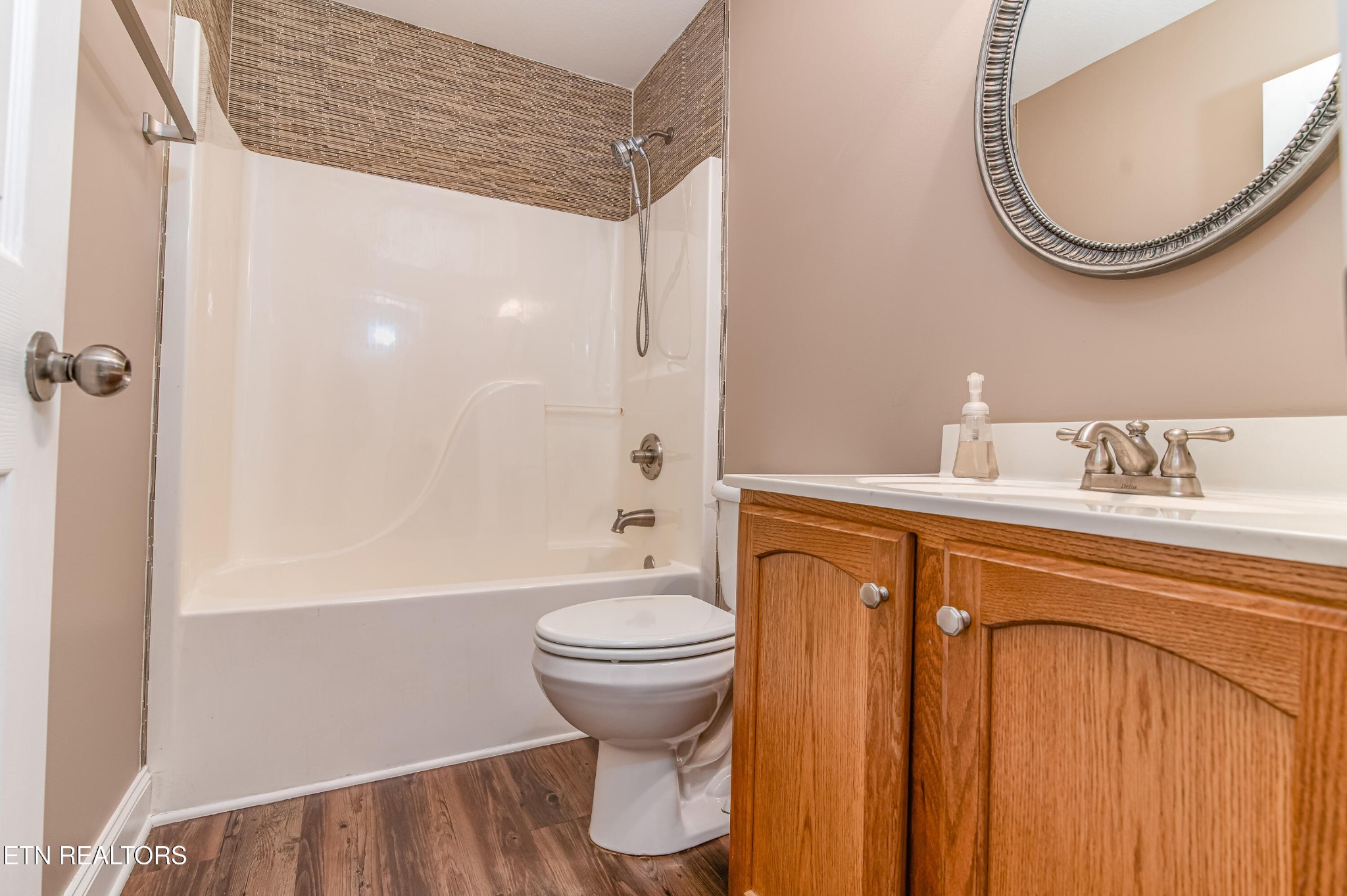 8007 Tazewell Pike Corryton, TN 37721 - Photo 23 of 43 a bathroom with a sink a toilet and a mirror