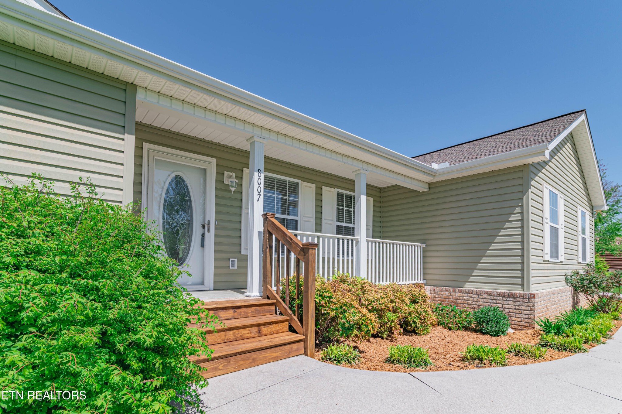 8007 Tazewell Pike Corryton, TN 37721 - Photo 3 of 43 a front view of a house with a yard