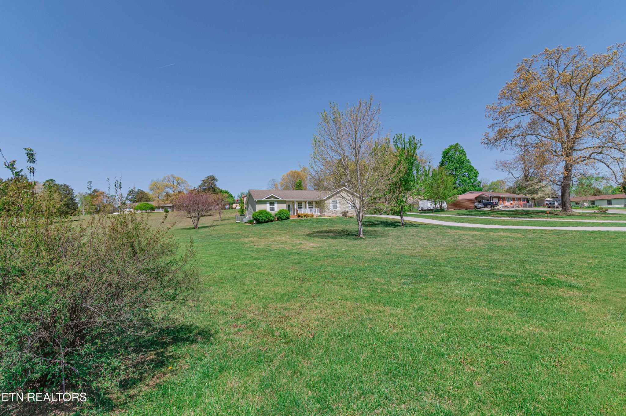 8007 Tazewell Pike Corryton, TN 37721 - Photo 38 of 43 a view of green field with house in the background