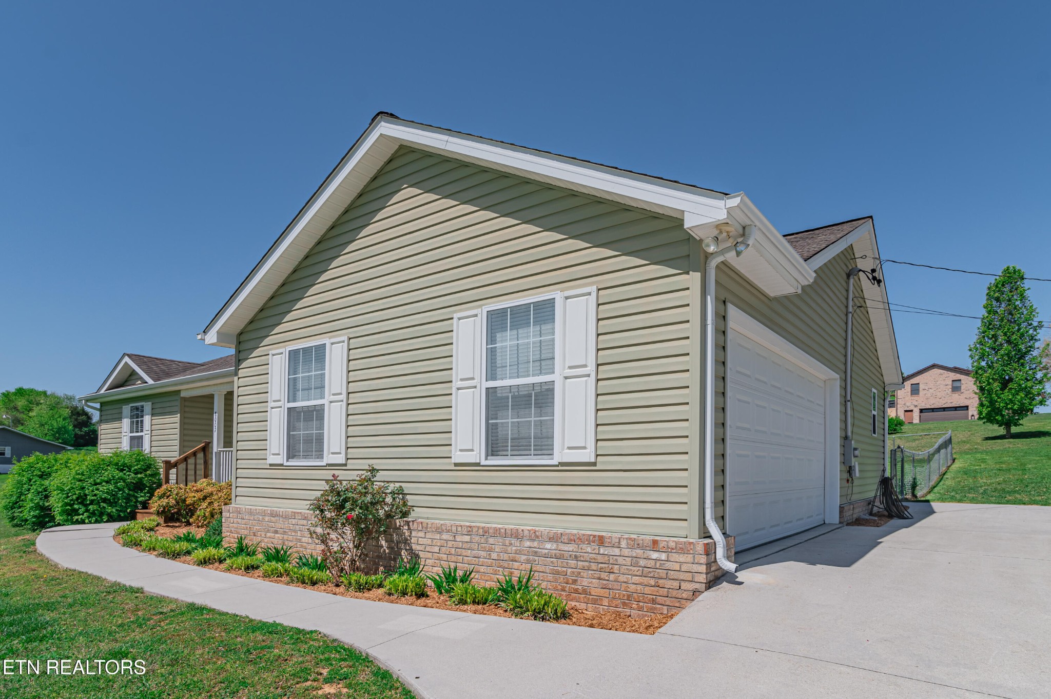 8007 Tazewell Pike Corryton, TN 37721 - Photo 42 of 43 a front view of a house with a yard