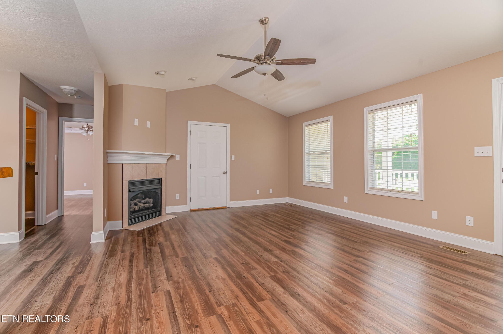 8007 Tazewell Pike Corryton, TN 37721 - Photo 5 of 43 wooden floor fireplace and windows in an empty room