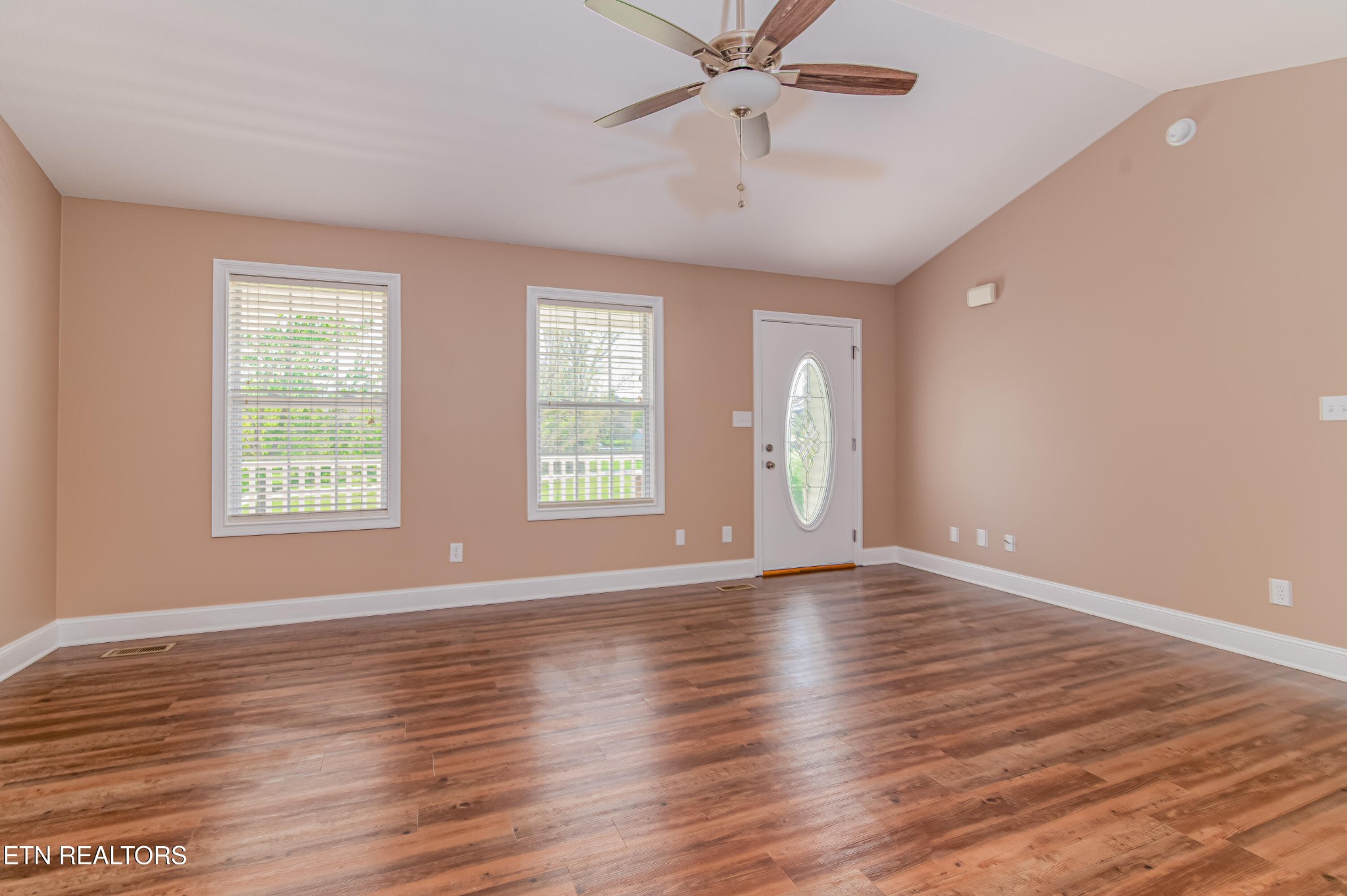 8007 Tazewell Pike Corryton, TN 37721 - Photo 6 of 43 a view of an empty room with wooden floor and a window