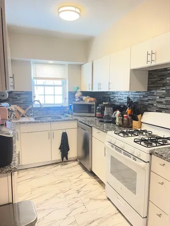a kitchen with a stove a sink and a refrigerator