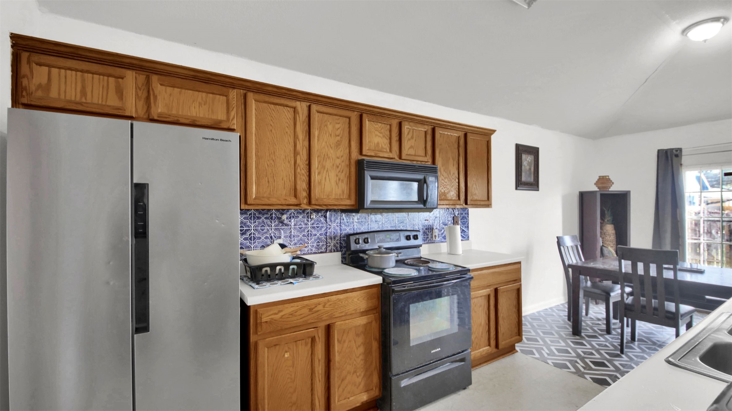 9609 Magna Carta Loop Austin, TX 78754 - Photo 16 of 30 a kitchen with stainless steel appliances granite countertop a refrigerator stove and sink