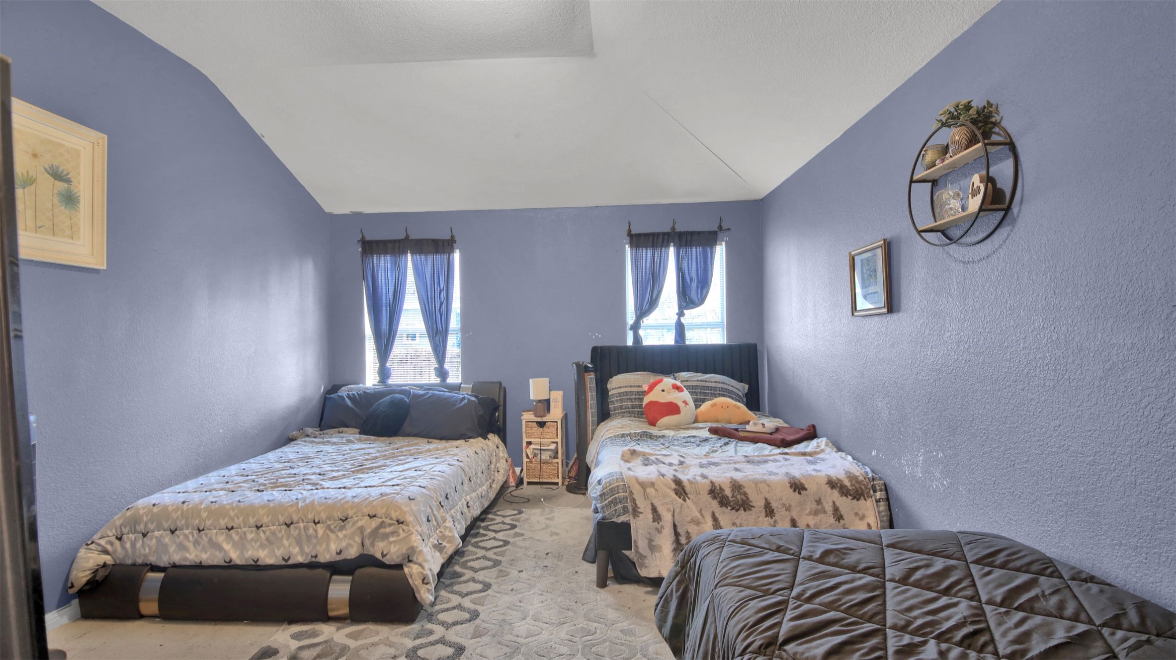 9609 Magna Carta Loop Austin, TX 78754 - Photo 19 of 30 a bedroom with a bed and painting on the wall